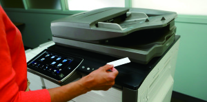 Woman using security card before using the HP Color MFP S956dn